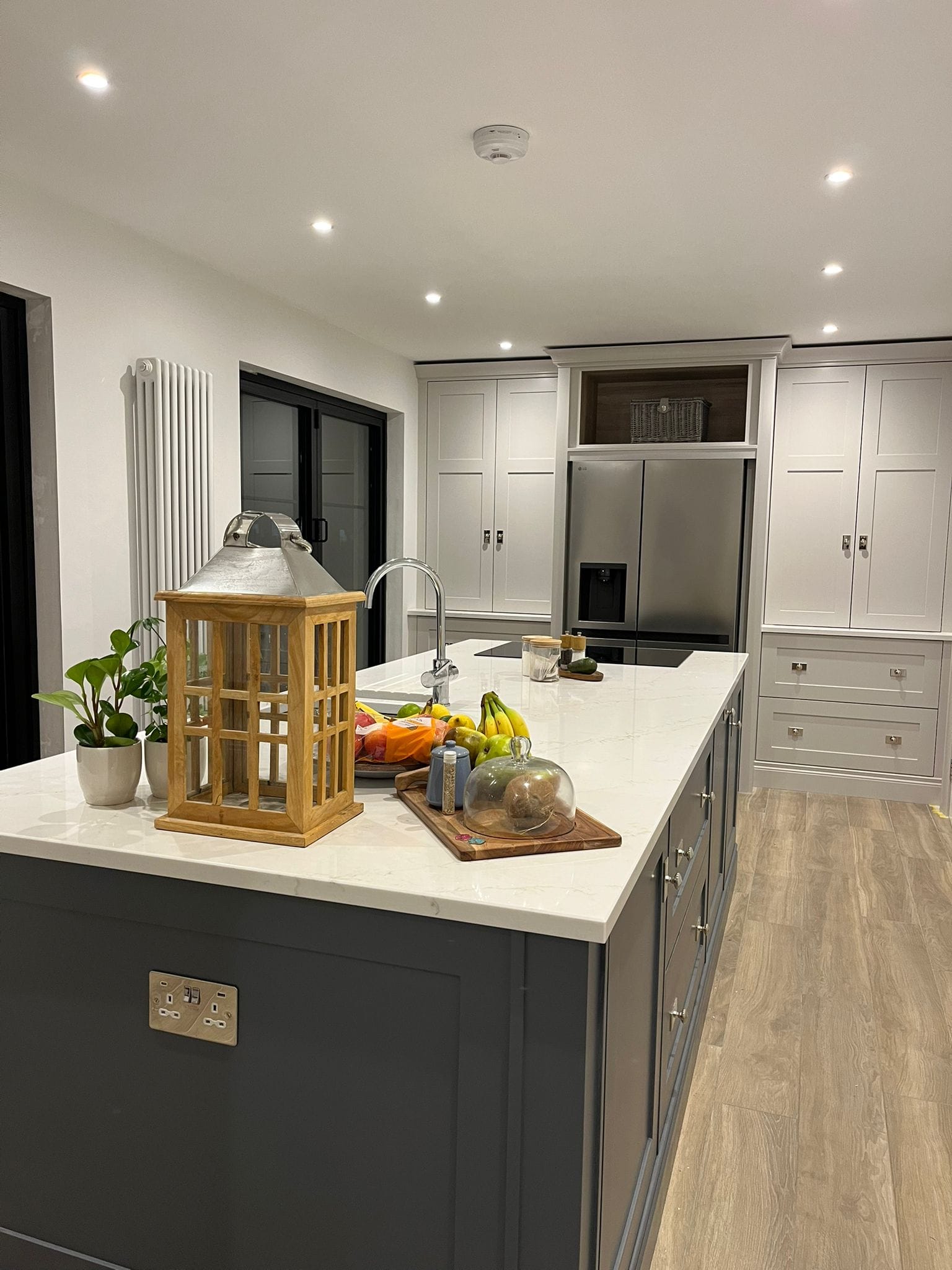 Kitchen island with dark cabinets and a bright open-plan layout
