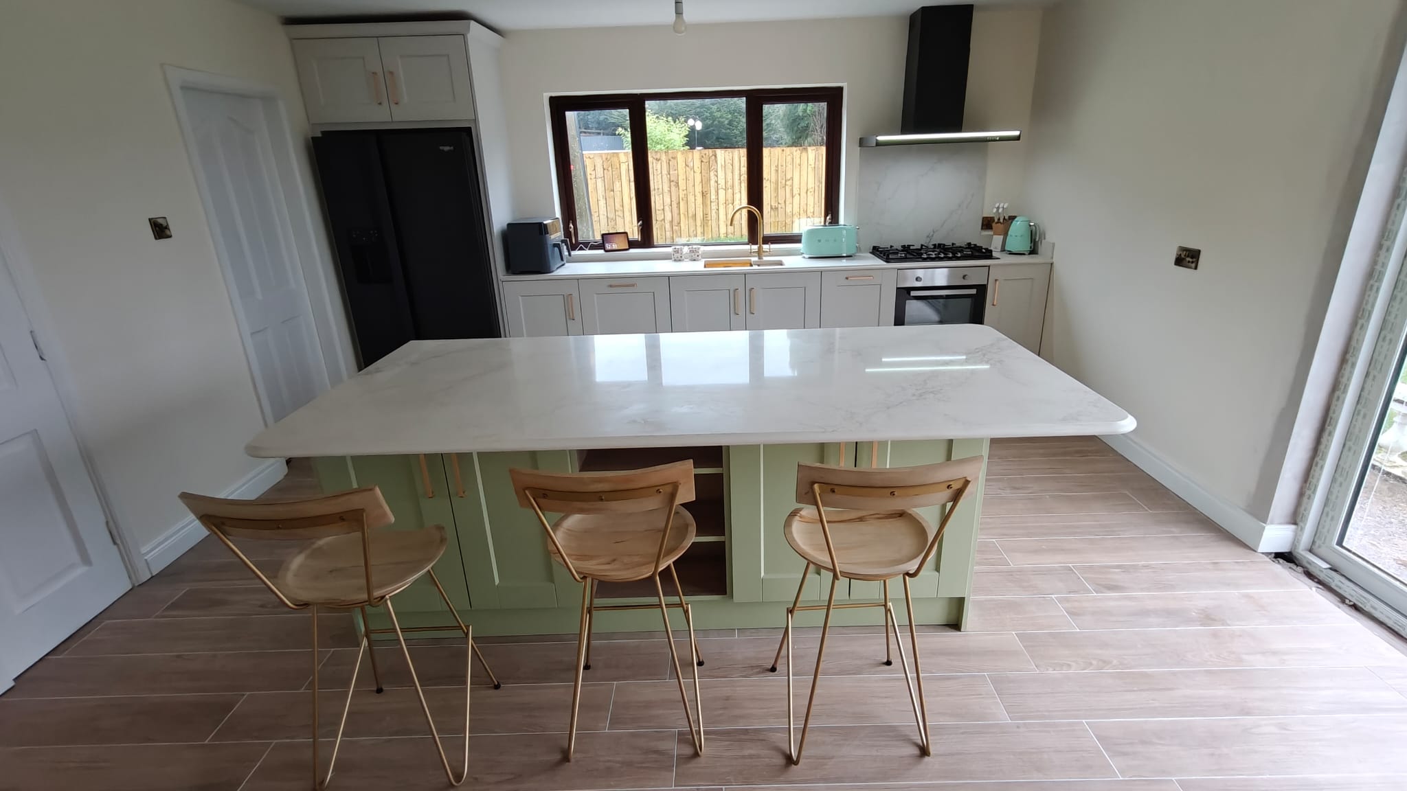 Open-plan kitchen with a central island and stools