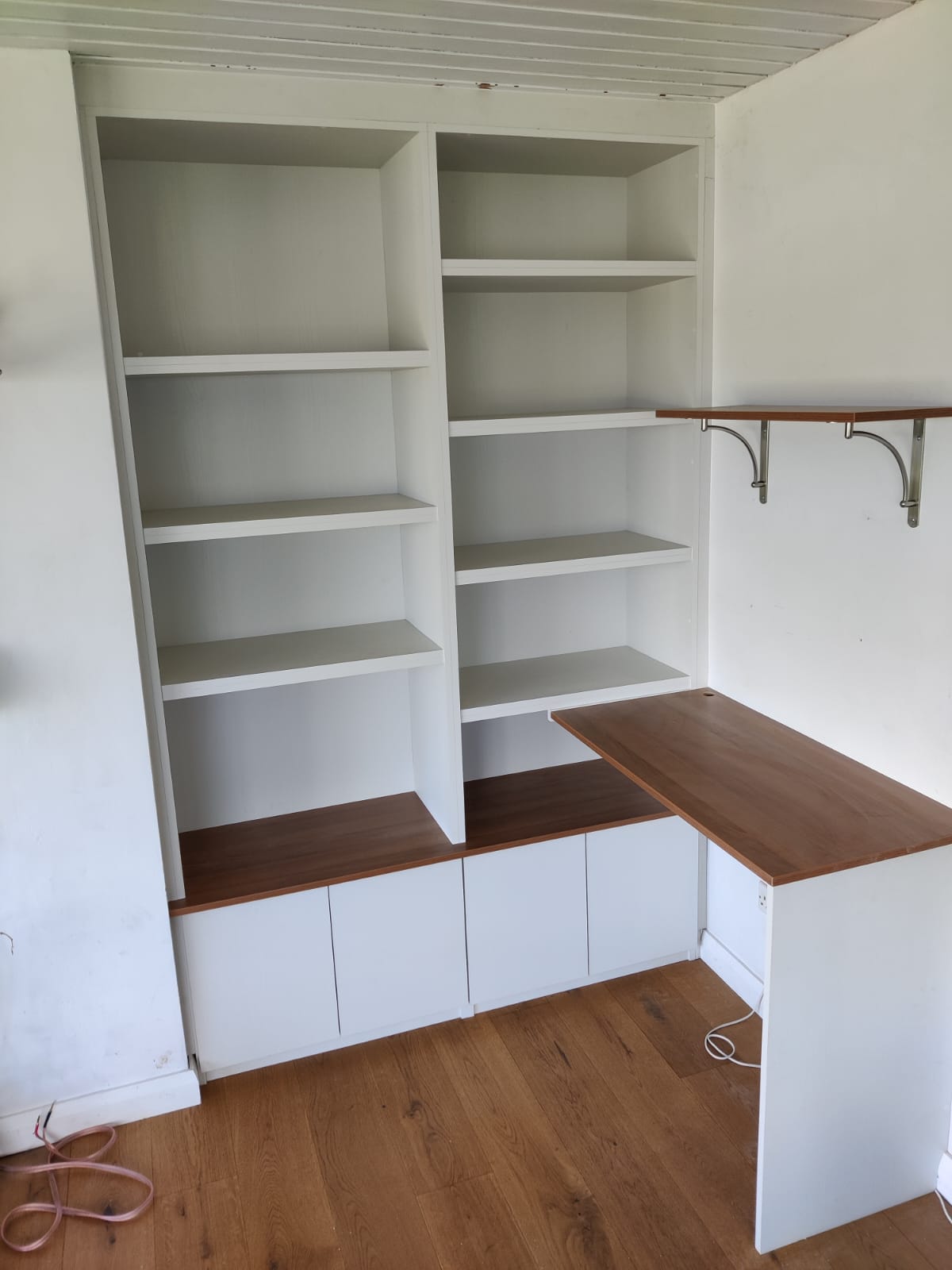 Built-in desk with white shelving and drawer storage